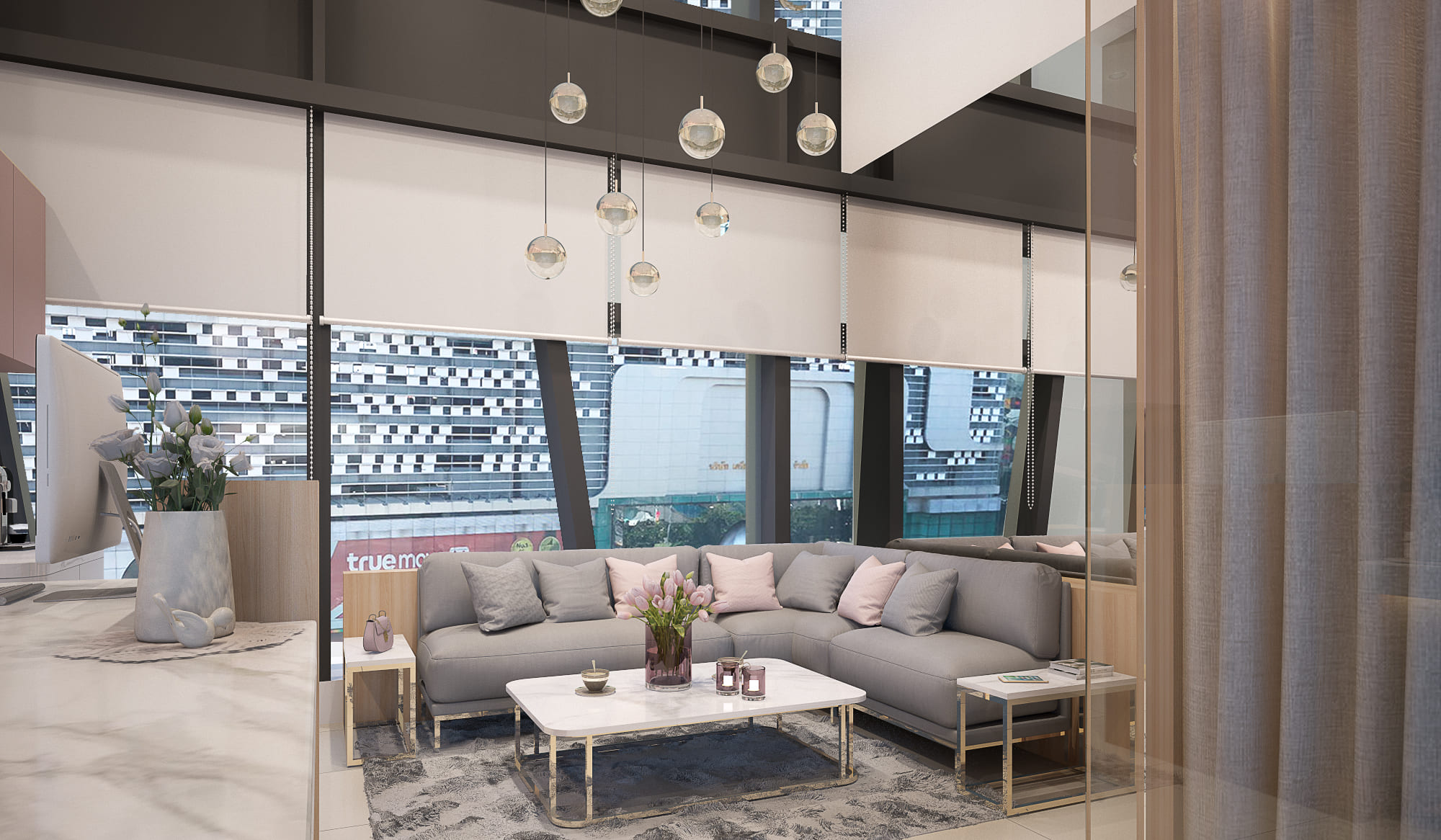 Clinic waiting lounge with a grey corner sofa, marble coffee table and a cluster of glass pendant lights hung through a double-height void