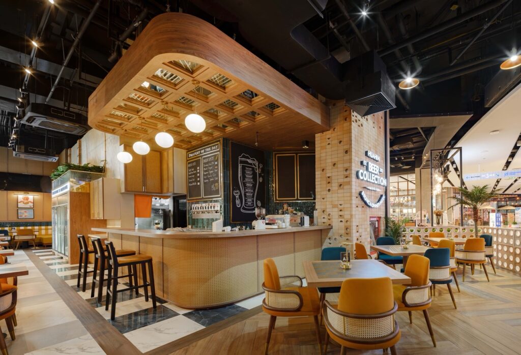 Back bar with chalkboard menus and counter stools at Beer Collection, Hua Hin