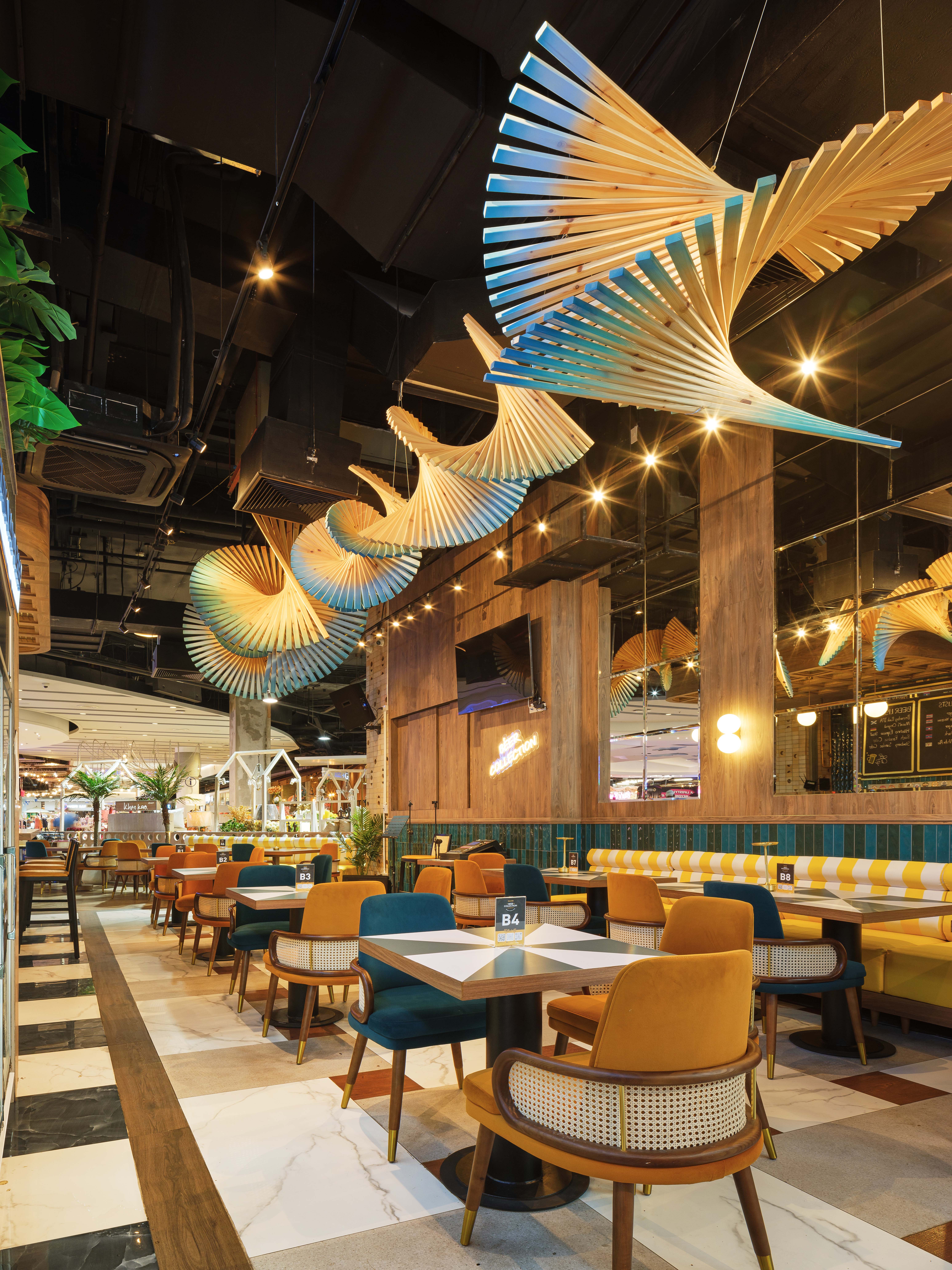 Pleated blue and timber fan installation across the ceiling of Beer Collection, craft beer bar interior design in Hua Hin