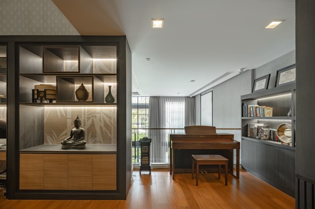 Mezzanine family room with piano, teak flooring and backlit display cabinet