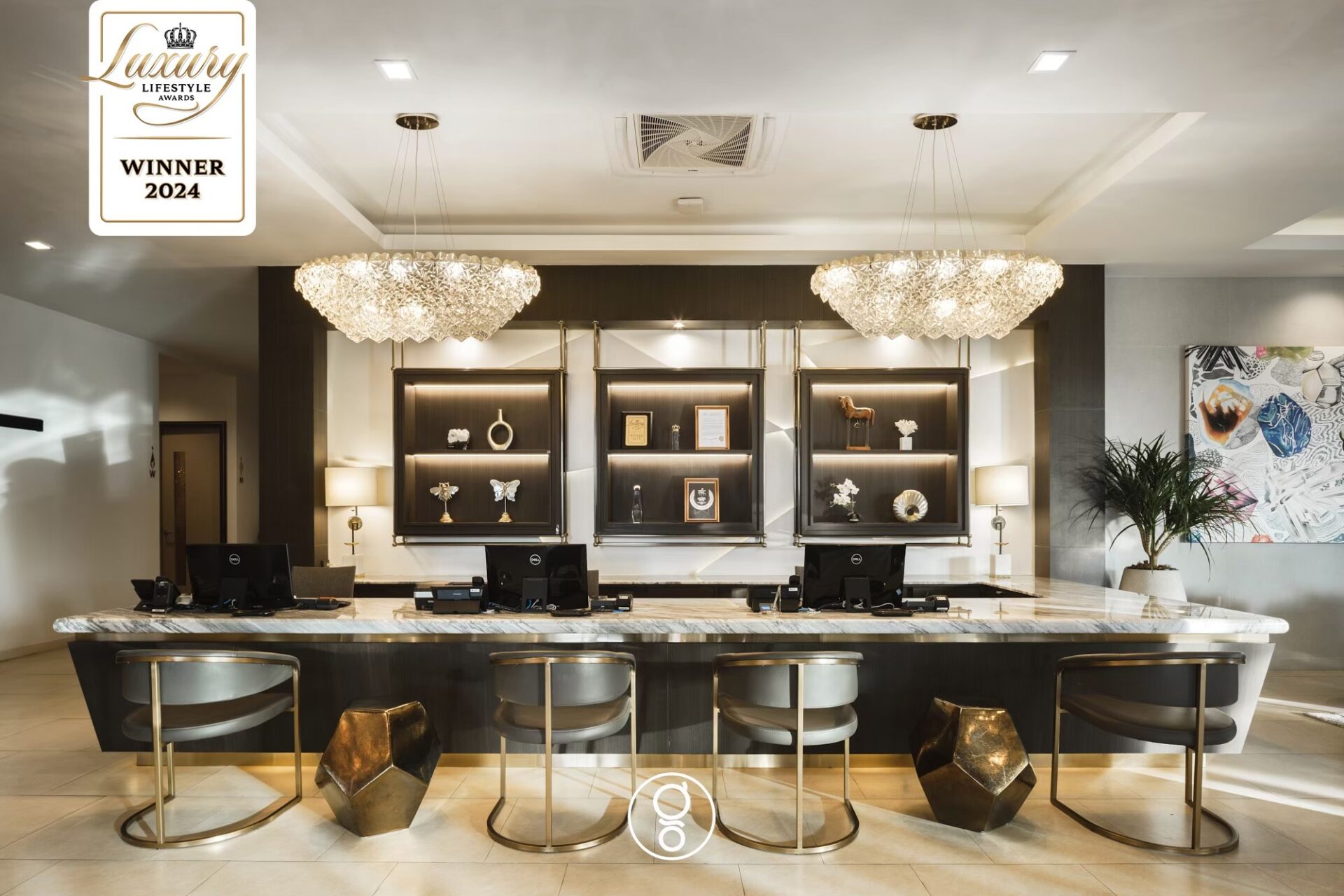 Long marble reception counter with crystal chandeliers at La Miniera Pool Villas Pattaya