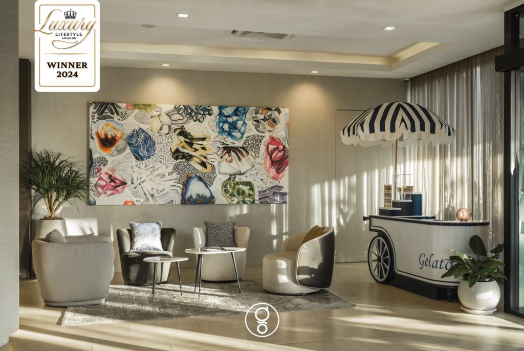 Lobby seating with Italian gelato cart and large abstract artwork at La Miniera Pool Villas