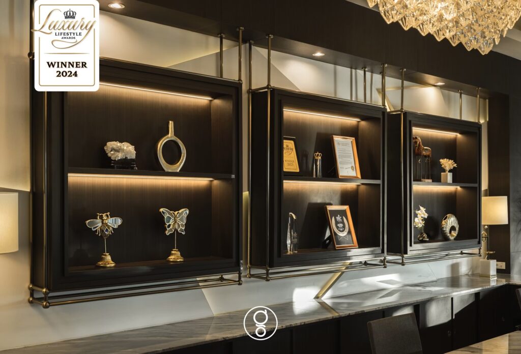 Illuminated bronze display vitrines with mineral specimens above the reception counter