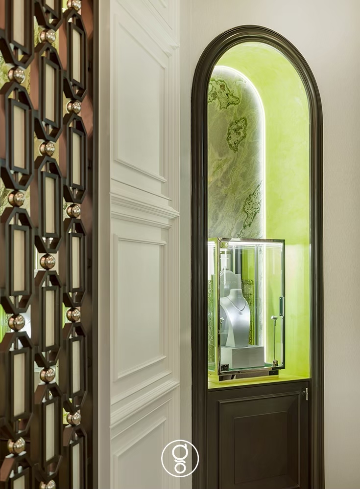 Bronze screen and backlit display niche in the Scintillion jewellery store interior