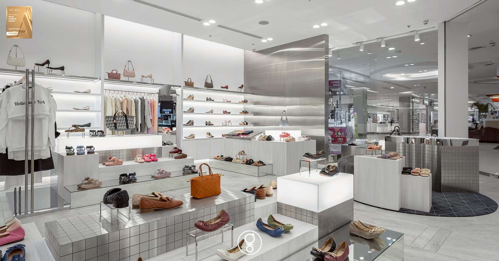Low stepped display plinths in limewashed timber and metallic mosaic holding the centre of the SHU shop floor