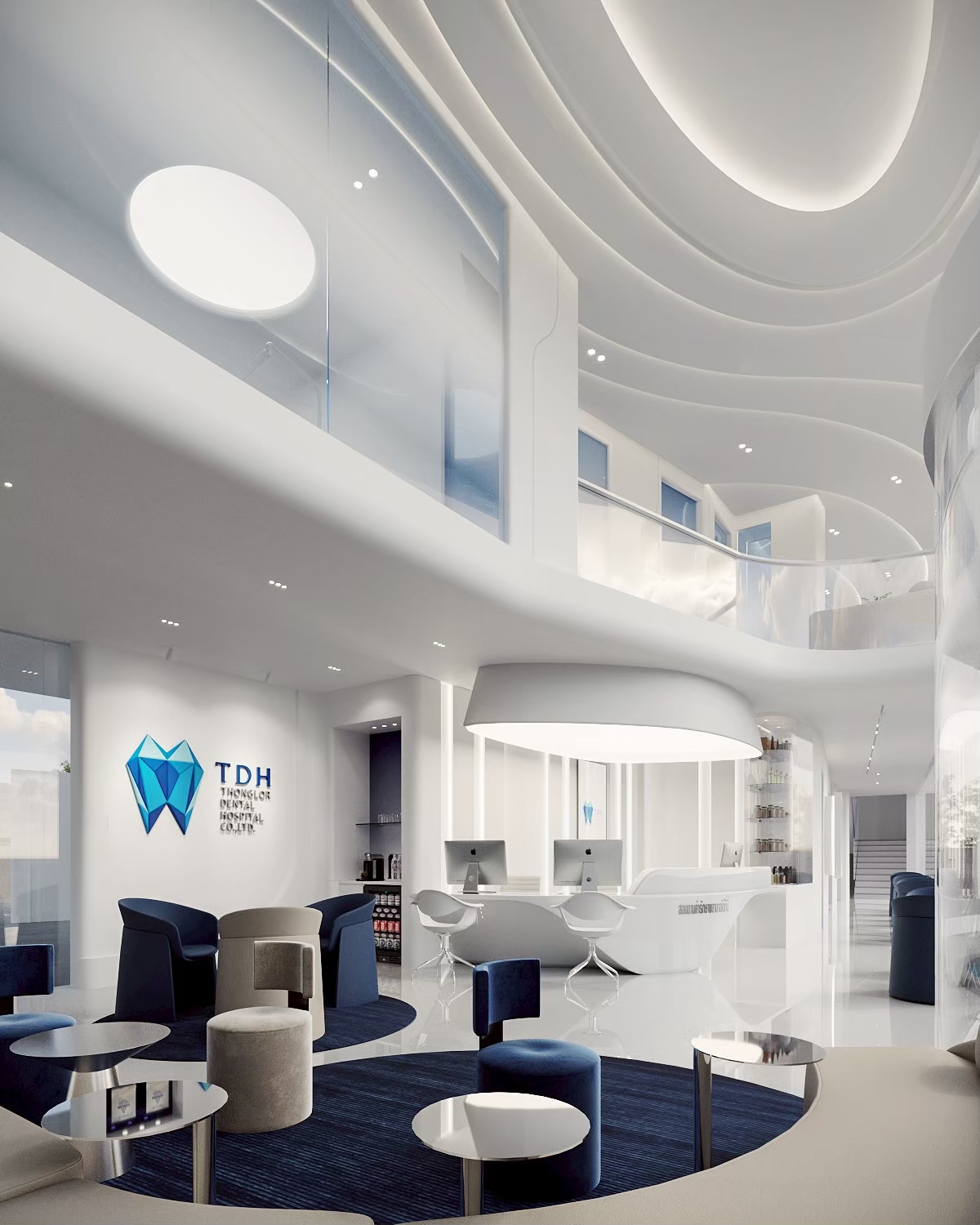 Double-height dental hospital lobby with curved balcony void, Bangkok