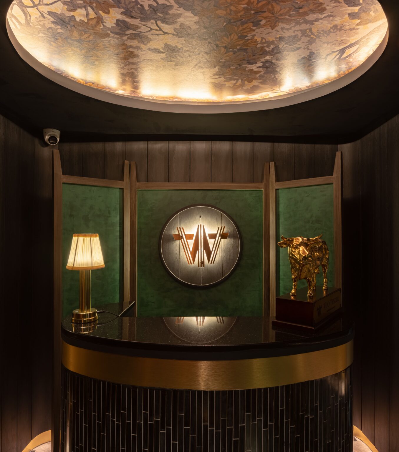 Entrance vestibule with the house mark in brass on green panelling