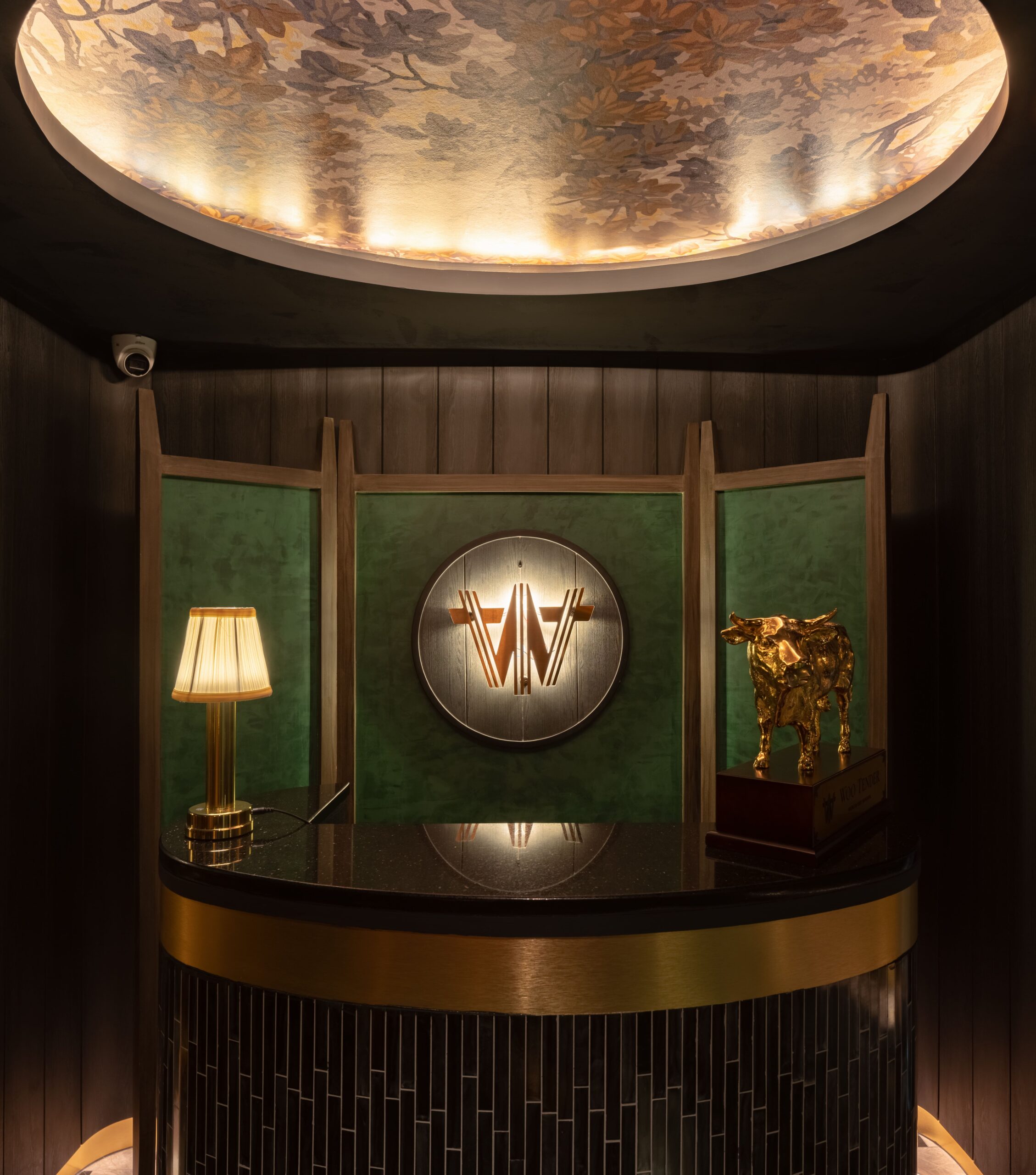 Entrance vestibule with the house mark in brass on green panelling