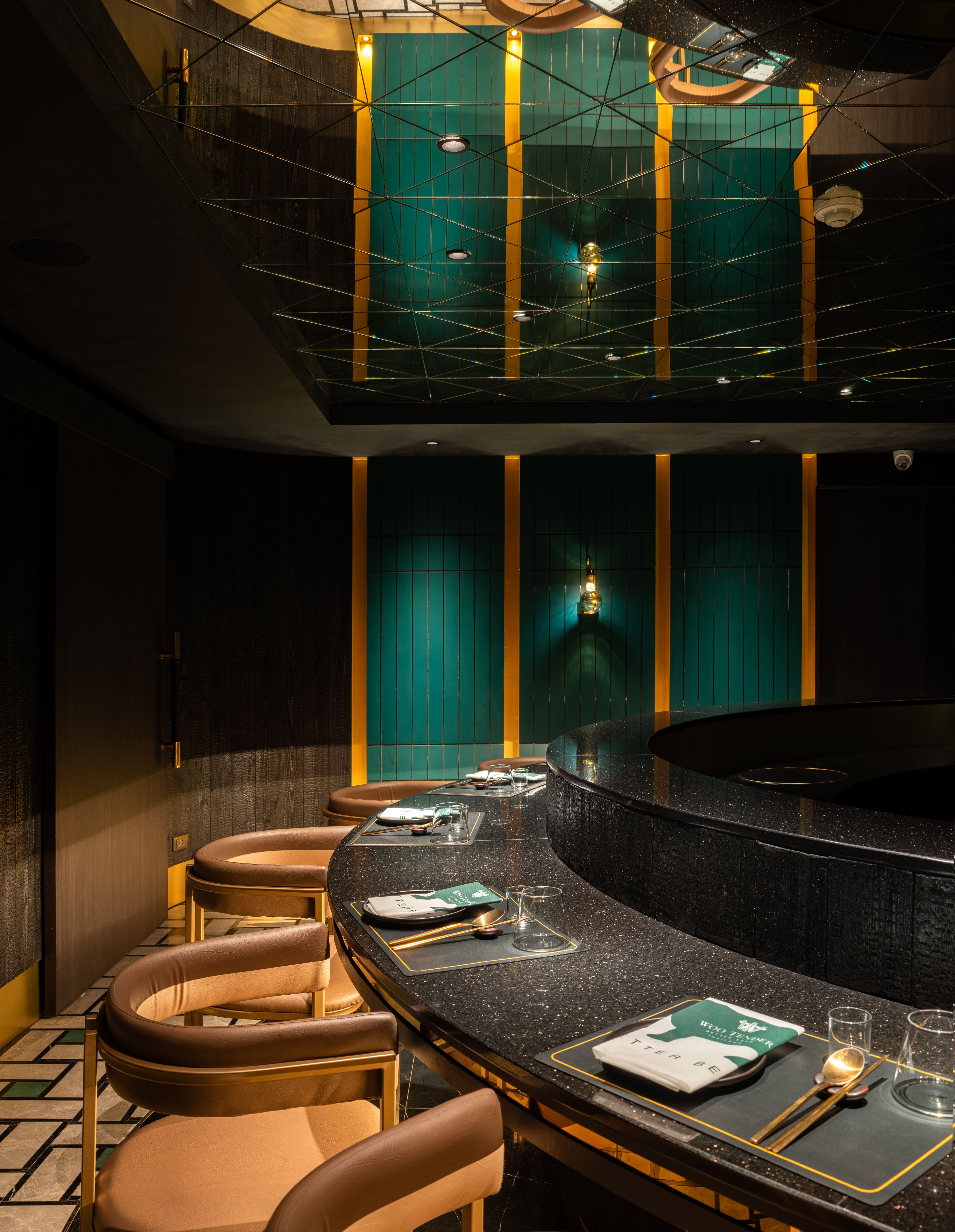 Counter detail with green fluted columns and brass reveals
