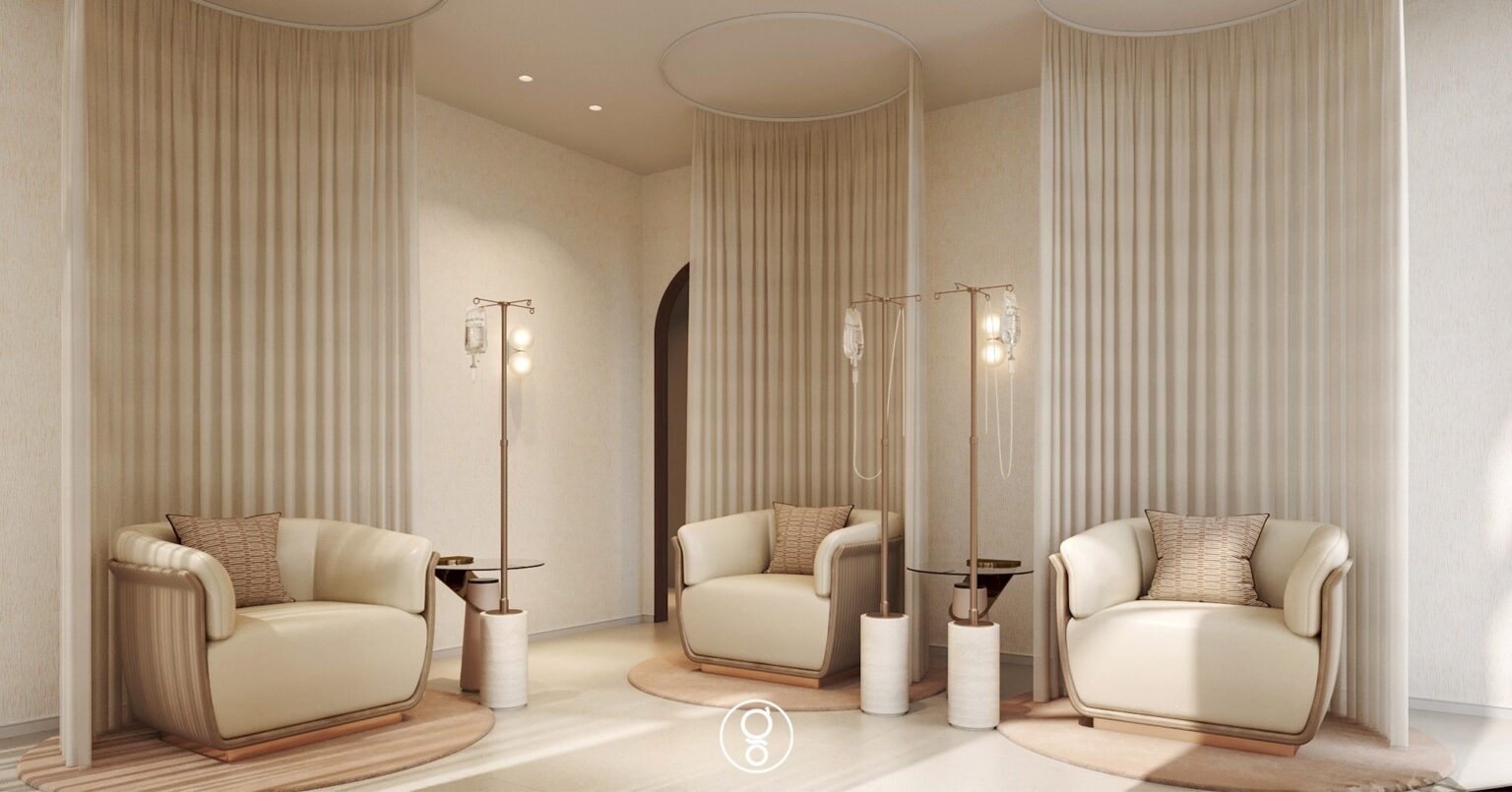 Vitamin drip lounge with curtained alcoves, cream leather armchairs and lit drip stands