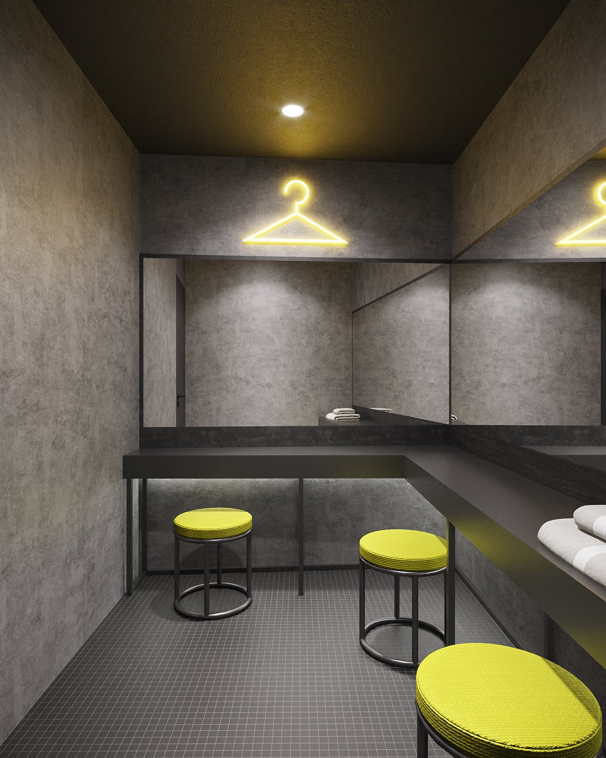 Ironfit reception wall close-up — backlit perforated yellow panel, stencil logo, black pendant lights and stepped yellow reception counter, interior design by Gratitude Design