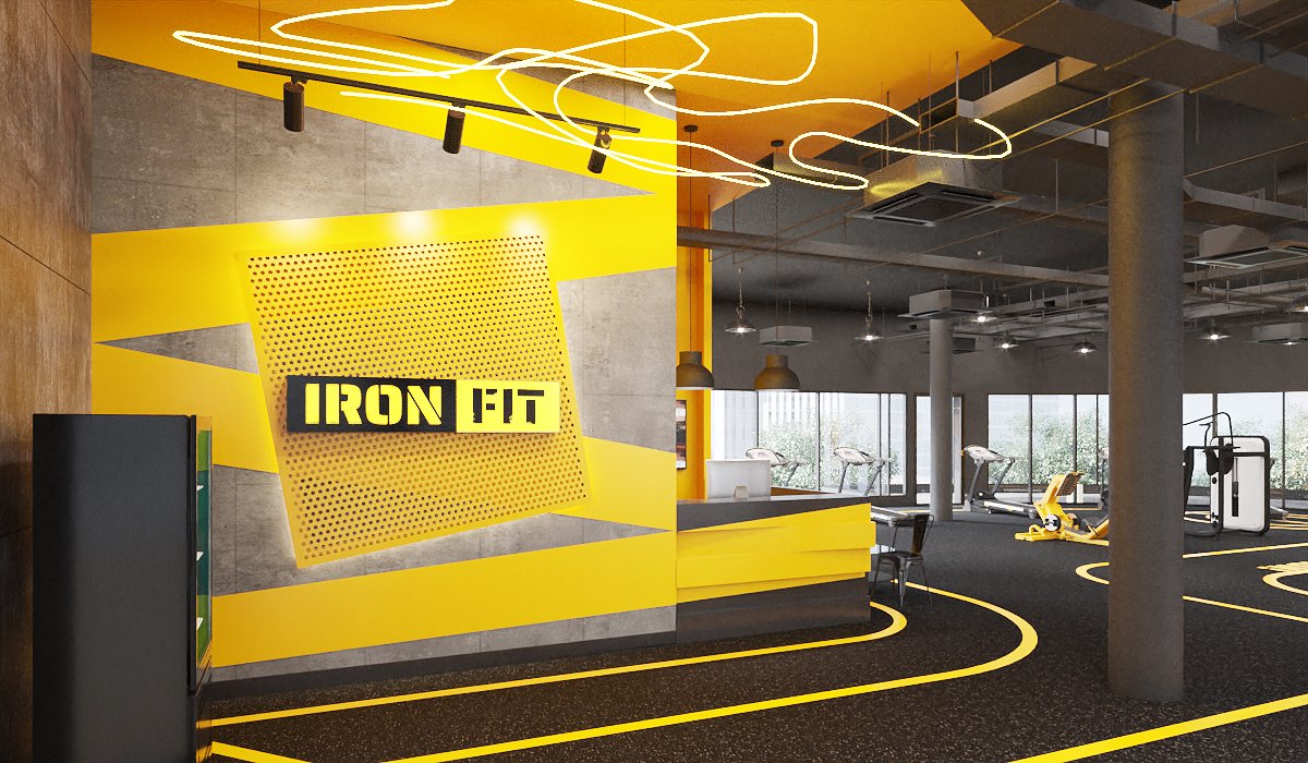 Ironfit reception desk — stepped charcoal and yellow counter, yellow feature wall with screen, supplement display and café seating, interior design by Gratitude Design