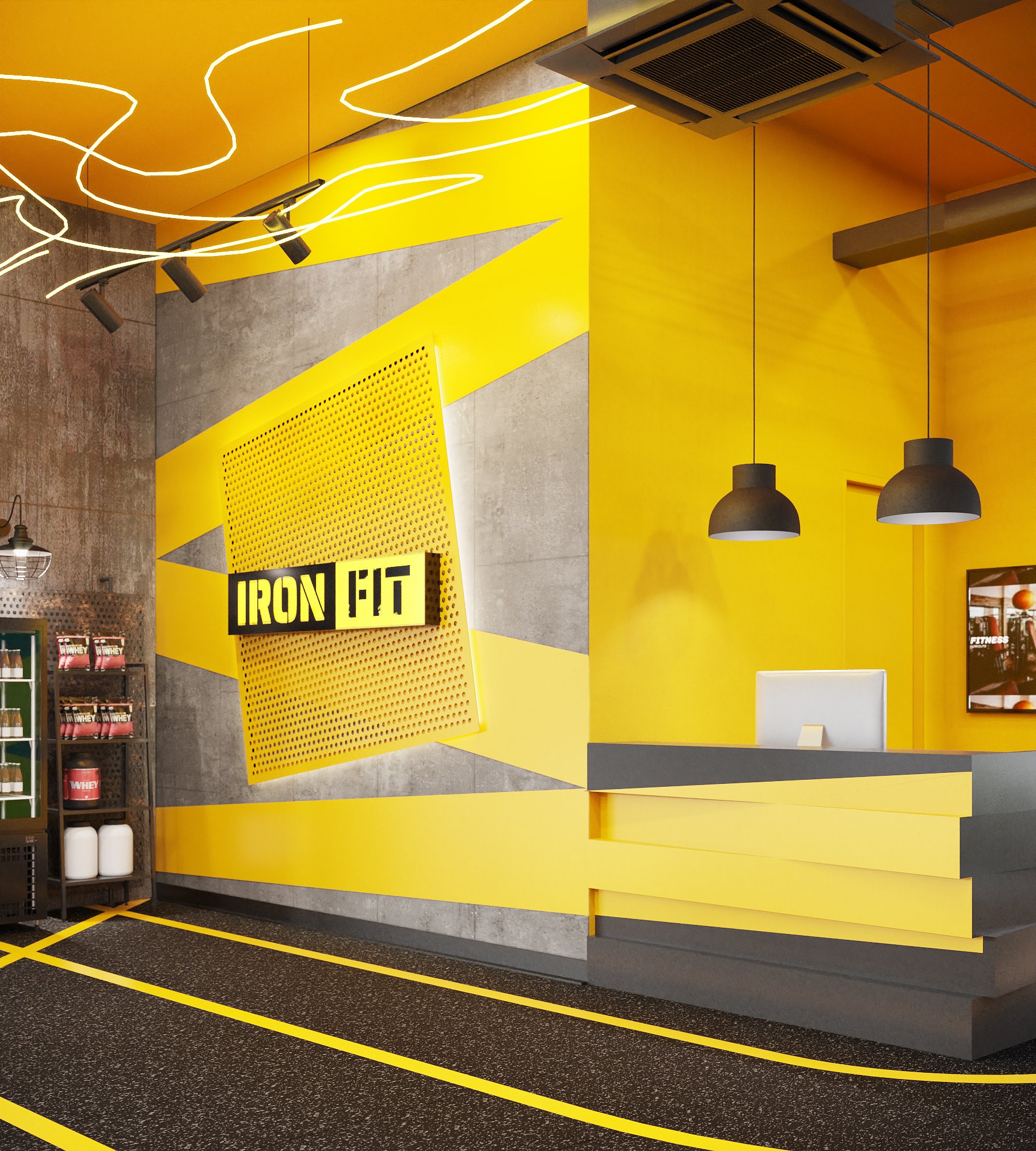 Ironfit free-weights area — yellow cable crossover machine, squat rack and benches under industrial pendant lights, interior design by Gratitude Design