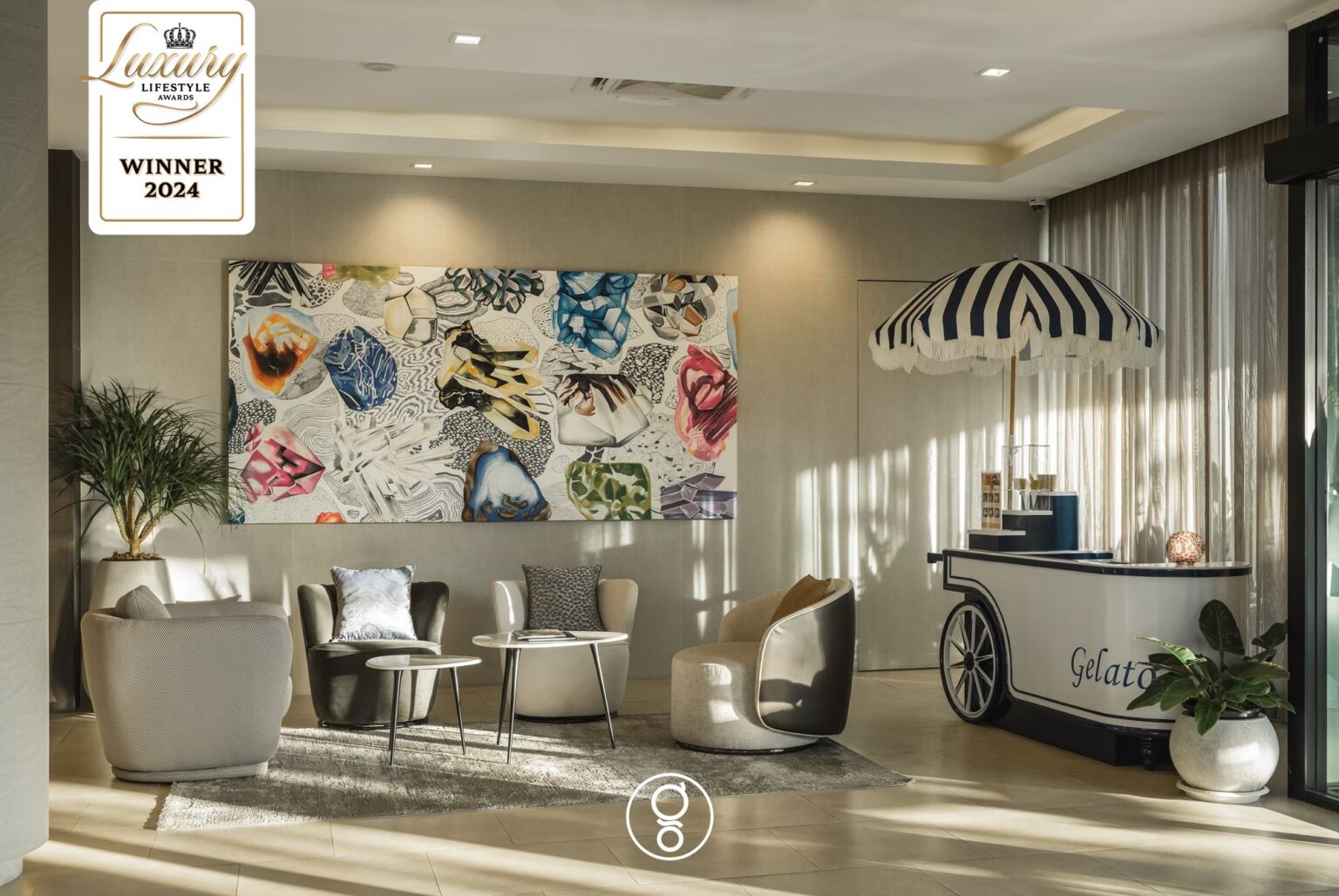 Lobby seating with Italian gelato cart and large abstract artwork at La Miniera Pool Villas