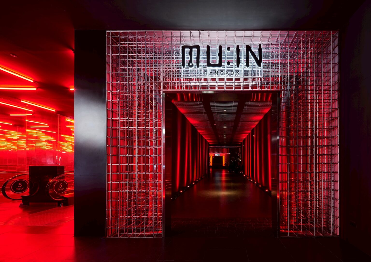 MU:IN Bangkok nightclub interior design — The MU:IN portal — a woven steel corridor announces the club before a drink is poured