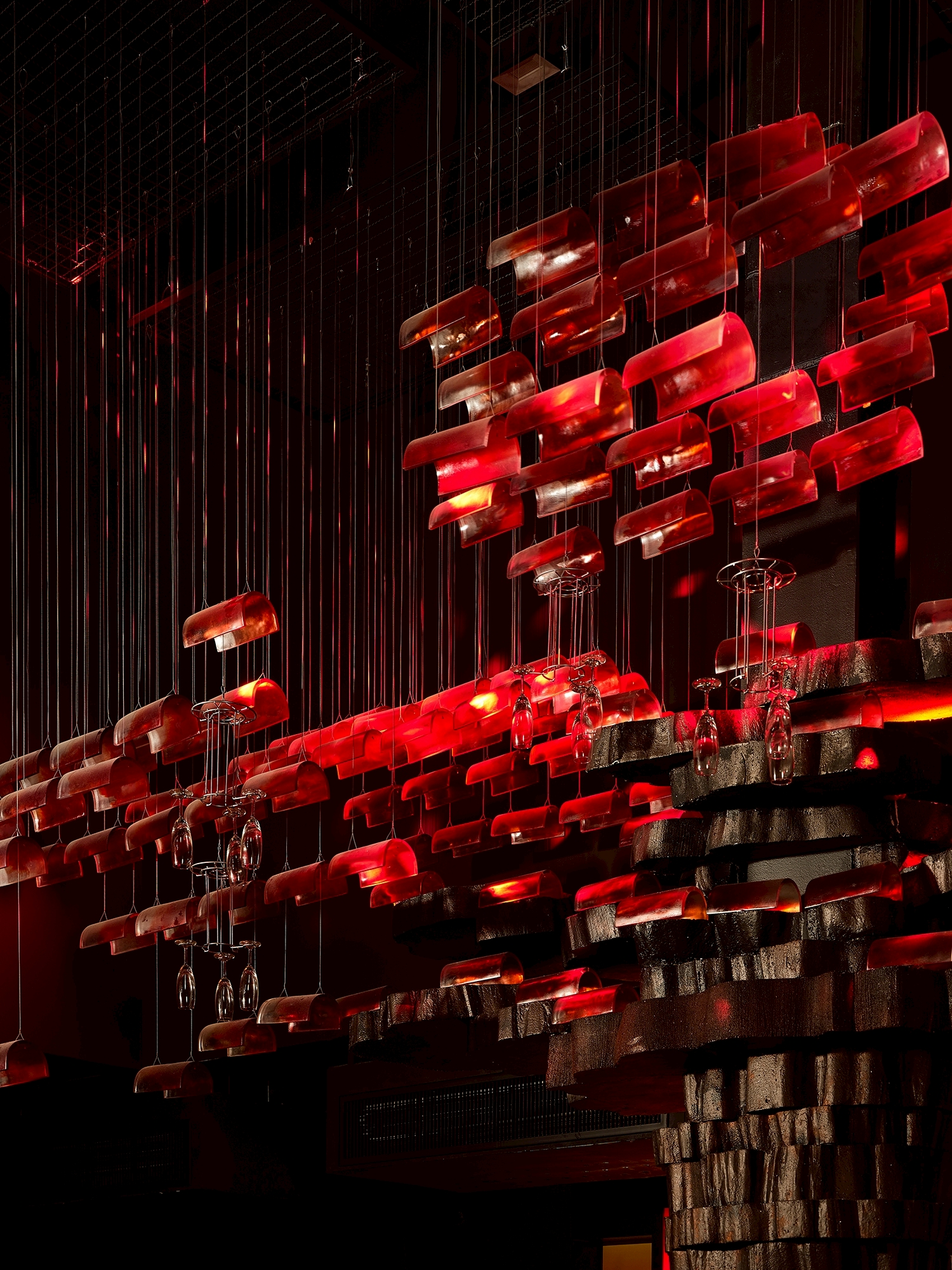 MU:IN Bangkok nightclub interior design — Ceiling detail — sculpted blocks catch the red wash