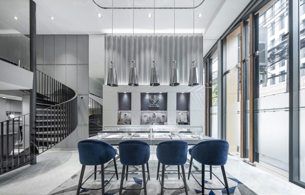 Engagement ring store interior design at Petch Thailand, Surawong Road Bangkok — seated diamond counter, fluted feature wall and mezzanine stair