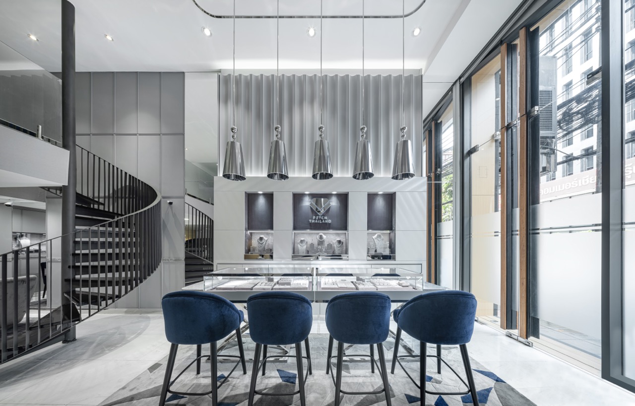 Engagement ring store interior design at Petch Thailand, Surawong Road Bangkok — seated diamond counter, fluted feature wall and mezzanine stair