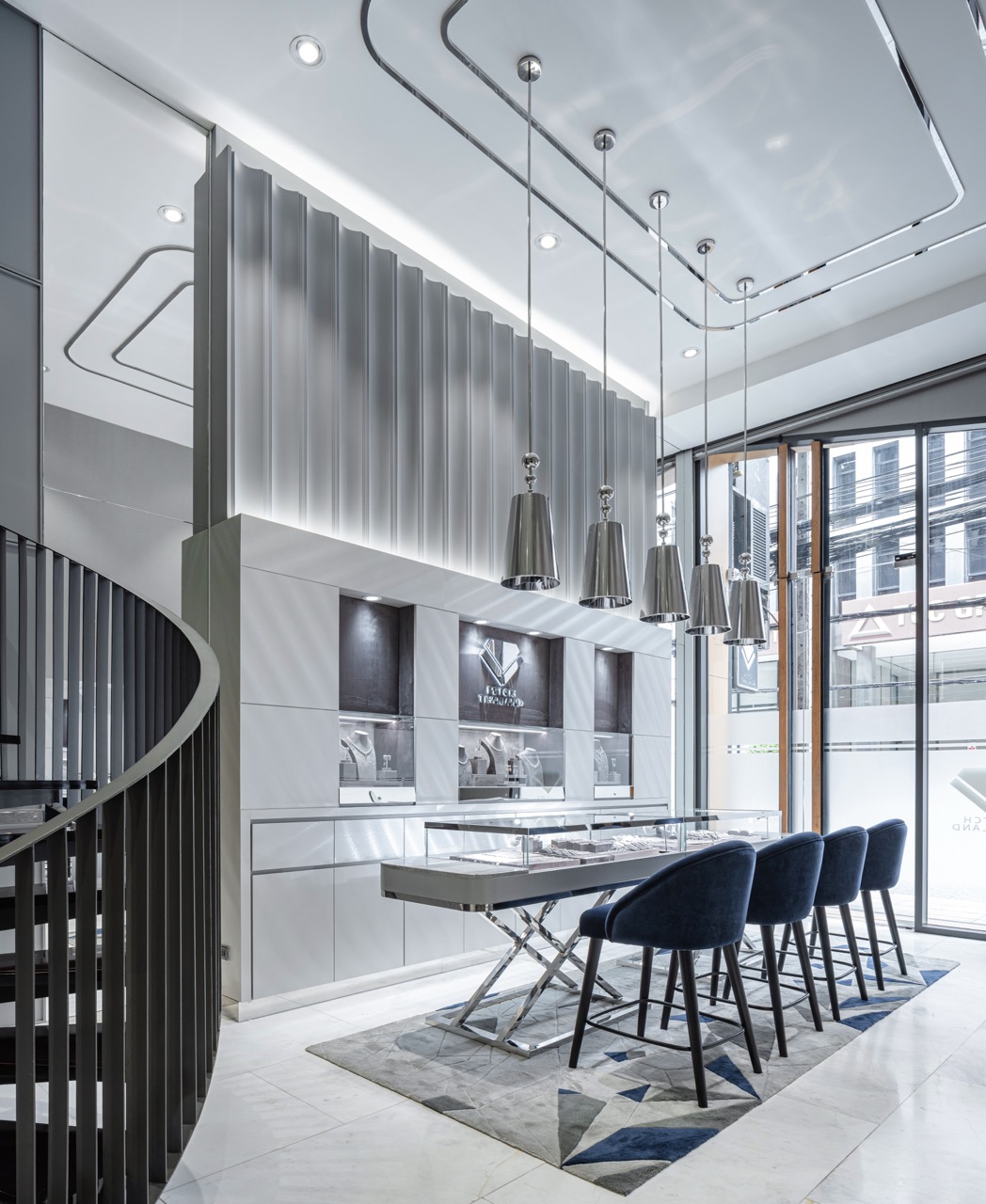 Double-height fluted feature wall, its profile drawn from diamond facet geometry