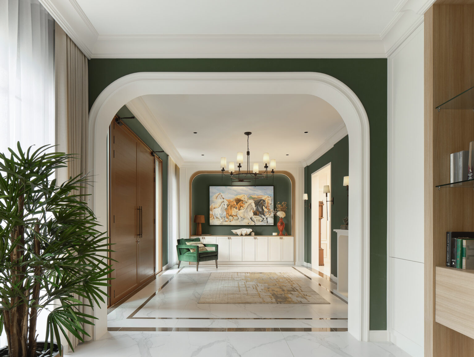 Grand Bangkok Boulevard entrance hall — rounded white arch framing a green gallery with a painting of running horses above white cabinetry, marble floor with dark inlay border
