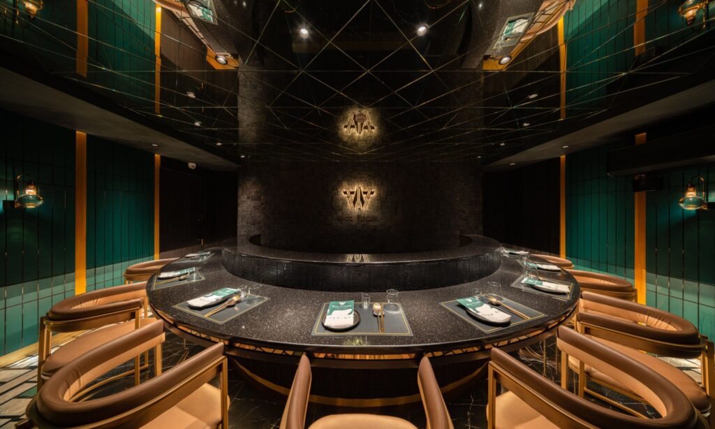 Curved omakase grill counter beneath a dark dome at Woo Tender