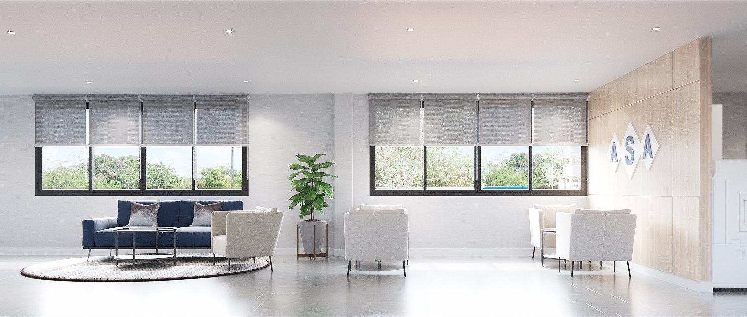 ASA Bangkok Office — open lounge with navy sofa and white armchairs beside a timber wall carrying the ASA diamond logo