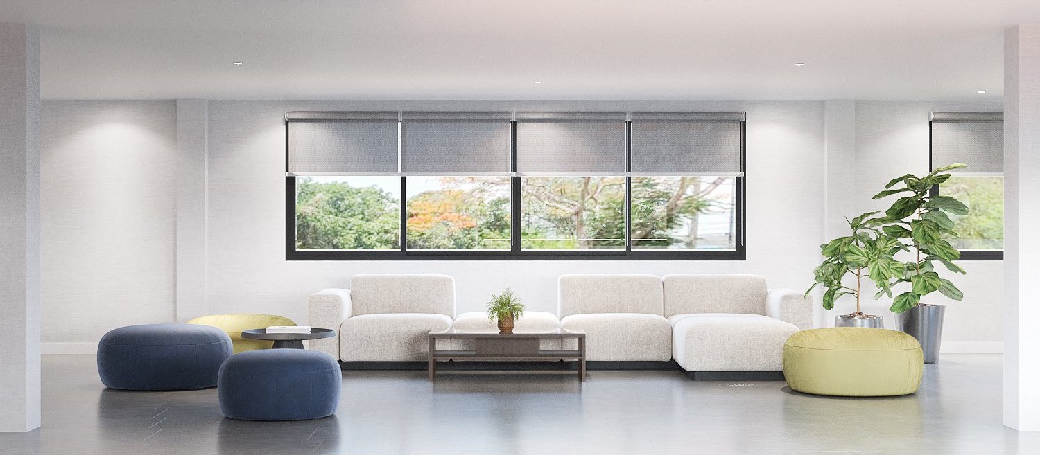 ASA Bangkok Office — staff lounge with a white modular sofa, navy and lime poufs and garden views