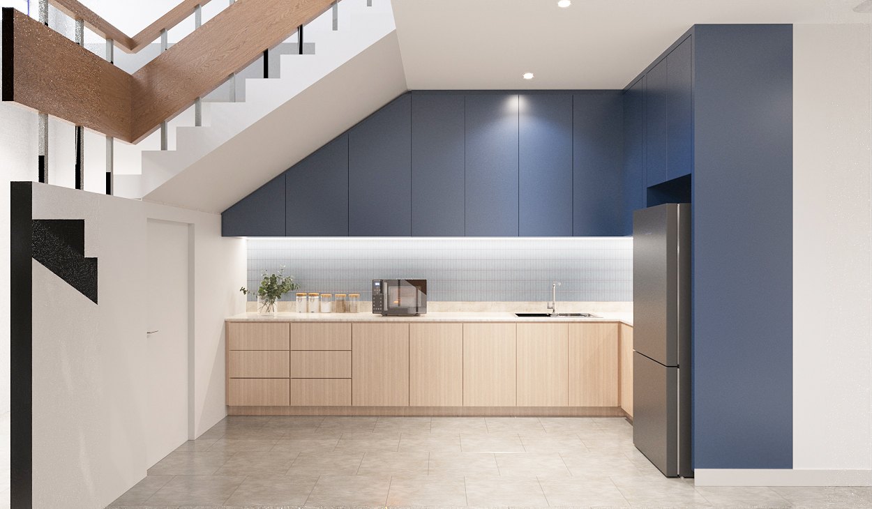 ASA Bangkok Office — kitchenette under the stair with deep-blue upper cabinets, timber base units and a lit tiled backsplash