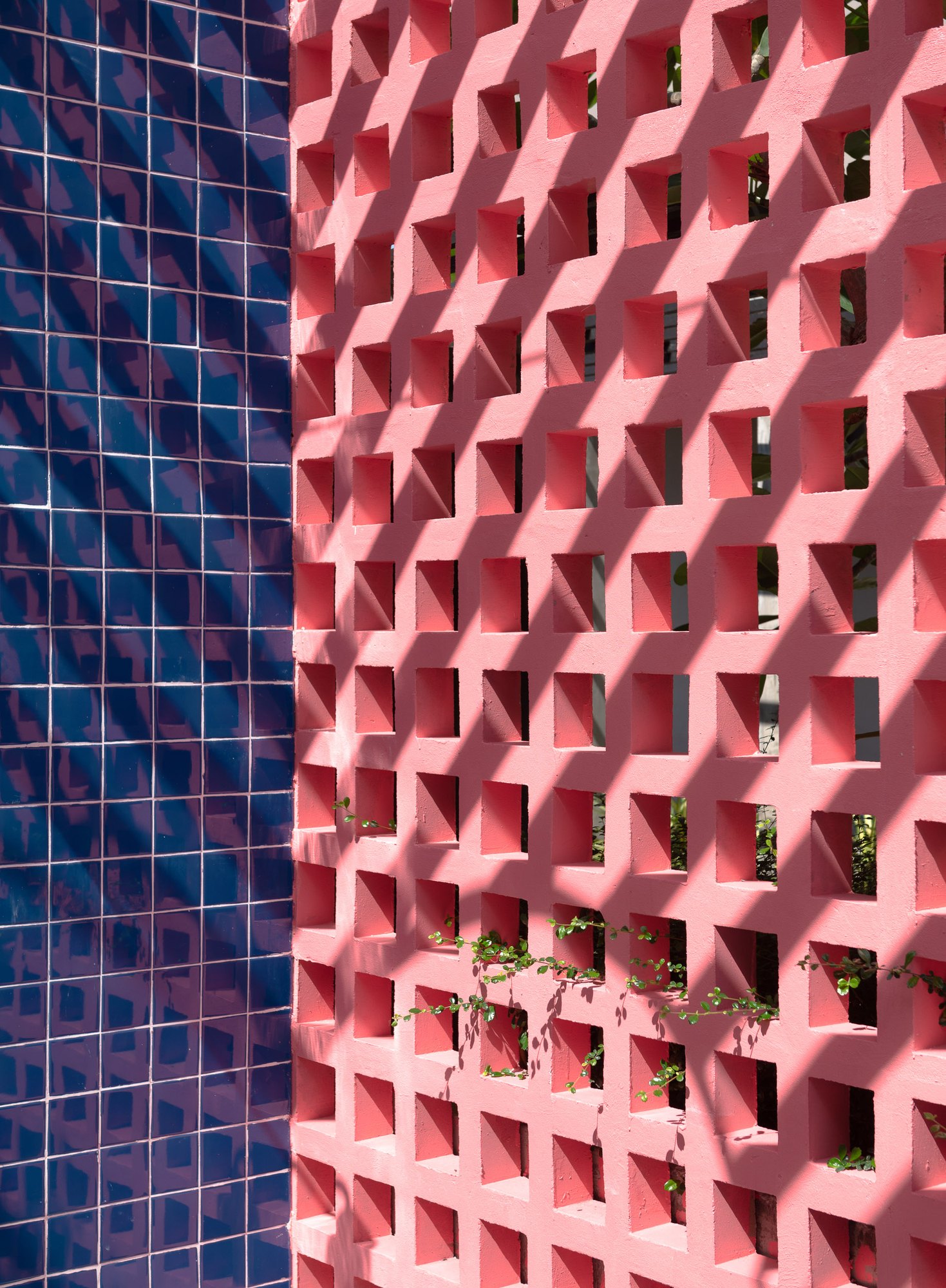 Navy glazed tiles beside a coral pink breeze-block screen at Sala Huahin