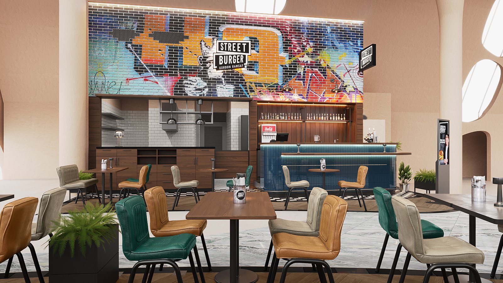 Street Burger by Gordon Ramsay restaurant interior design — graffiti-inspired feature wall on a brick-patterned surface above the open kitchen, white tiles, suspended lamps, timber cabinetry and green, tan and grey diner chairs